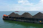 A barge loaded with coal anchored offshore in Indonesia.