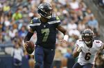 Seattle Seahawks quarterback Geno Smith (7) drops to pass as Chicago Bears' Kyler Gordon (6) closes in during the first half of a preseason NFL football game, Thursday, Aug. 18, 2022, in Seattle. (AP Photo/Caean Couto)