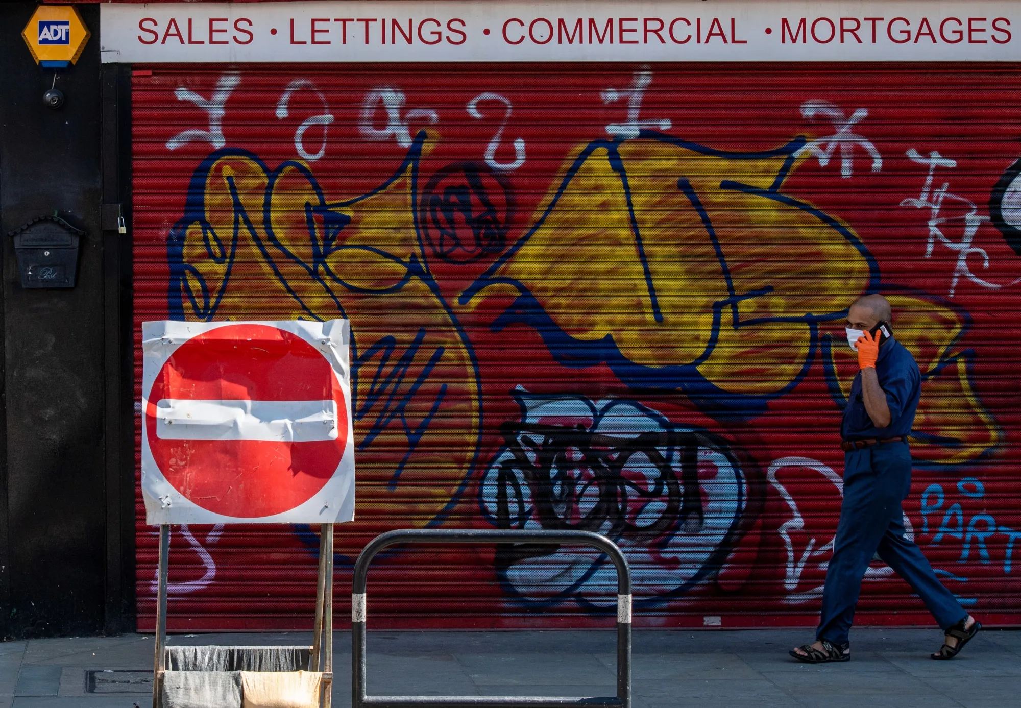 A pedestrian passes an estate agent in London, on April 21.