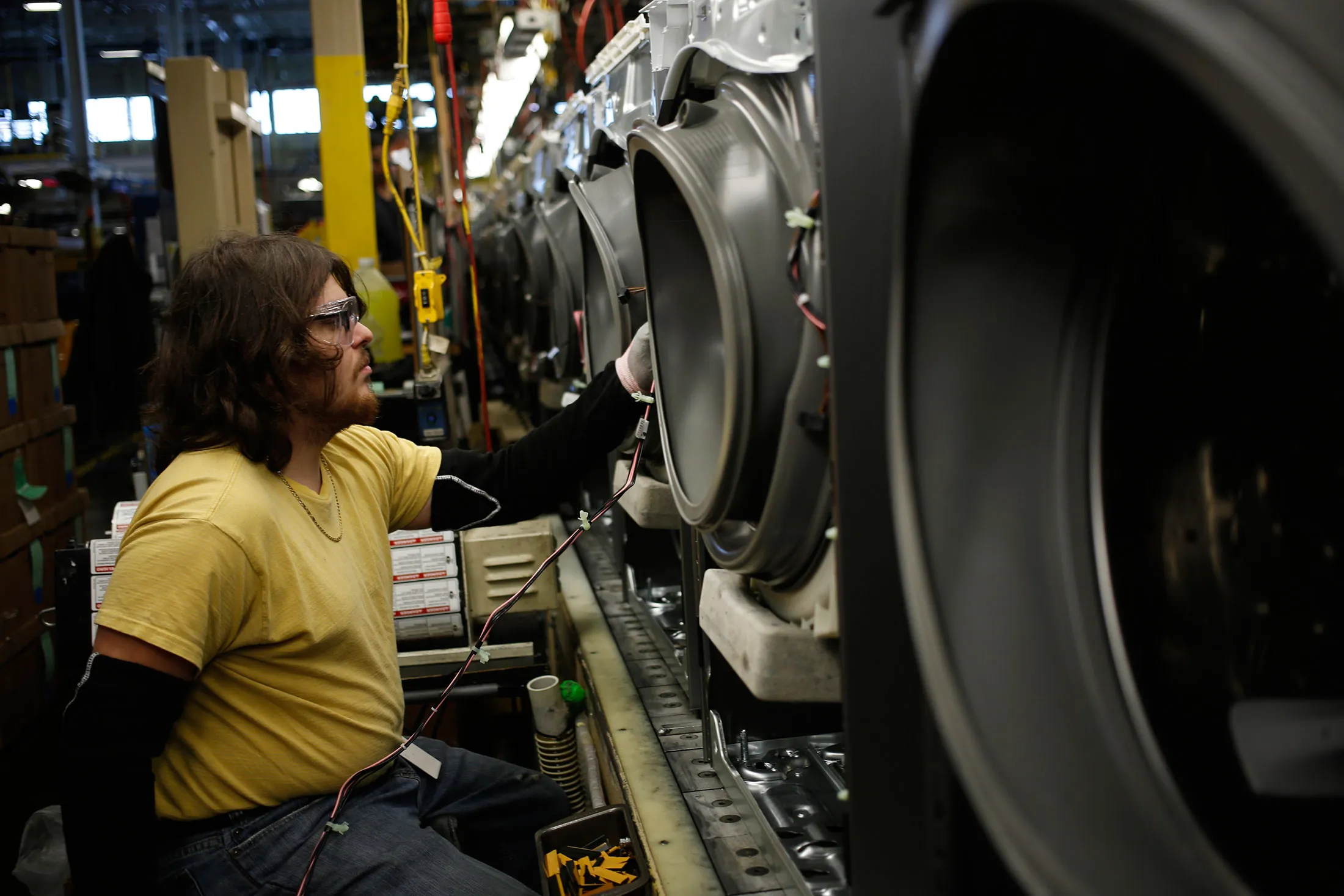 A worker assembles washing machines at the Whirlpool Corp. manufacturing facility in Clyde, Ohio, U.S., on Wednesday, Dec. 9, 2015. The U.S. Census Bureau is scheduled to release business inventories figures on December 11.

