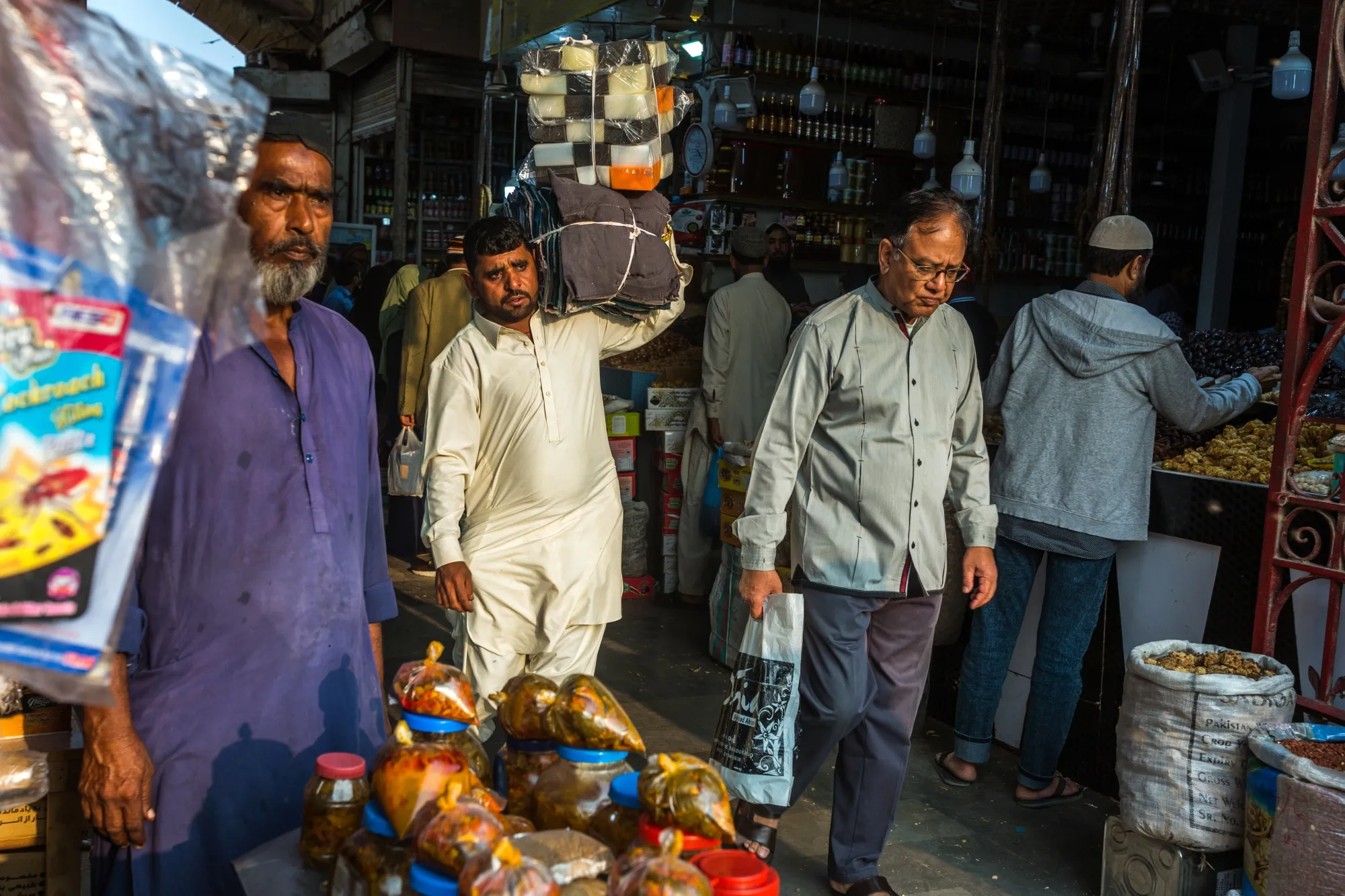 A customers carries his purchases at the Empress Market building in Karachi, Pakistan.