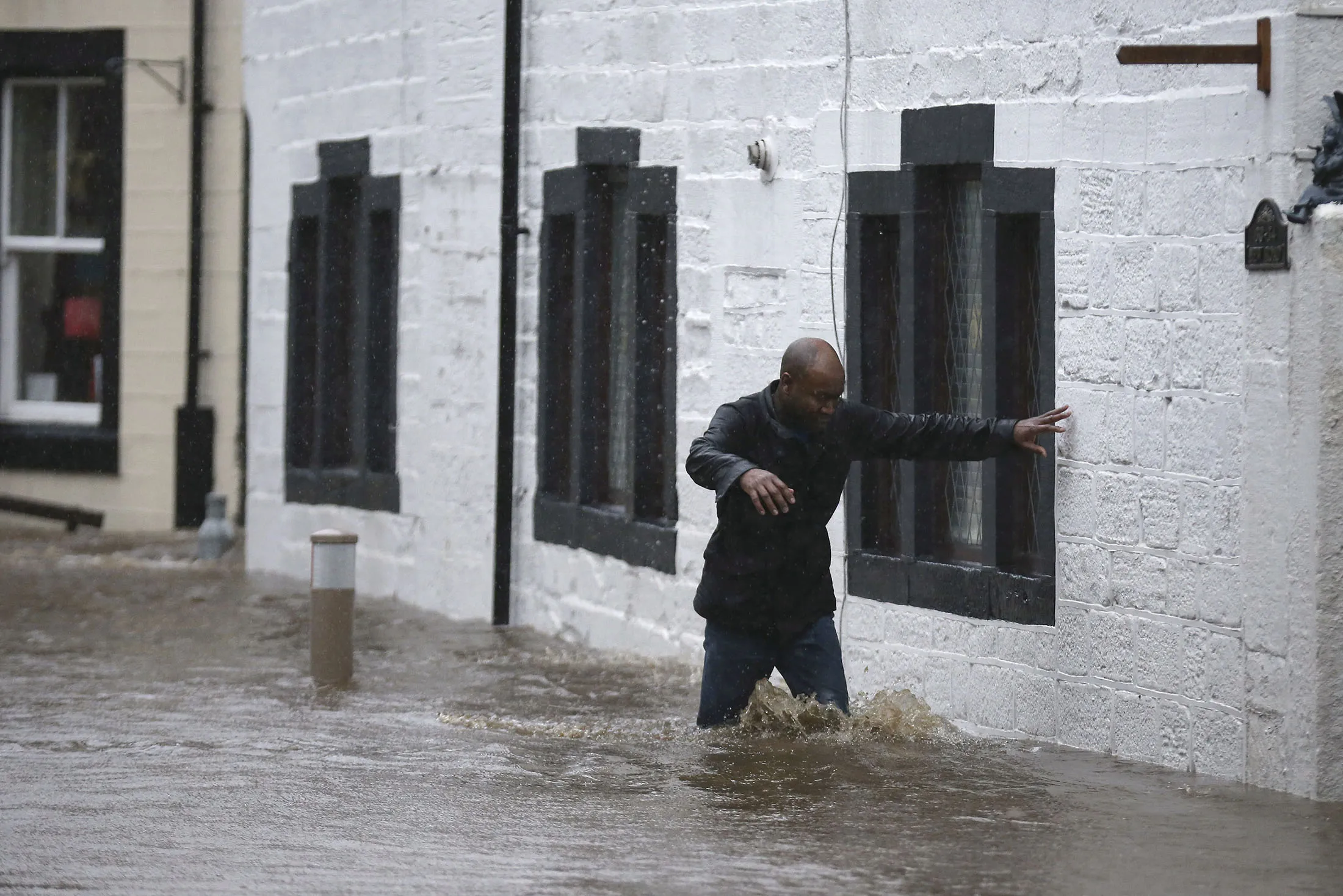 Residents battle against floodwater as the River Calder bursts its bank's in the Calder Valley town of Mytholmroyd
