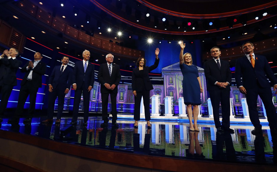 Democratic presidential candidates wave as they enter the stage for the second night of the Democratic primary debates in Miami.