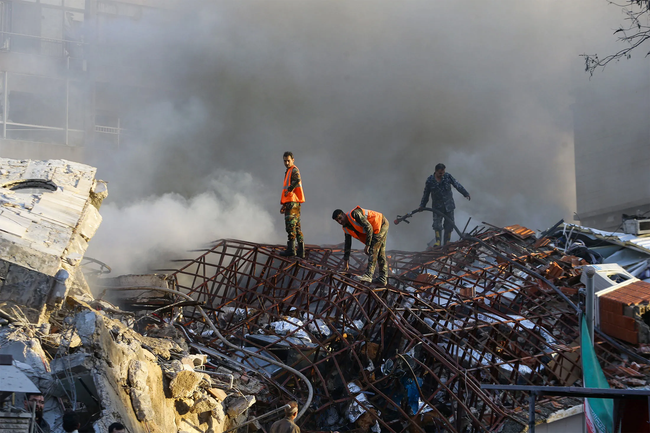 Emergency personnel at the site of strikes which hit a building next to the Iranian embassy in Syria's capital Damascus, on April 1.