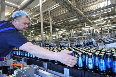 An Employee Inspects Bottles Of Baltika Lager
