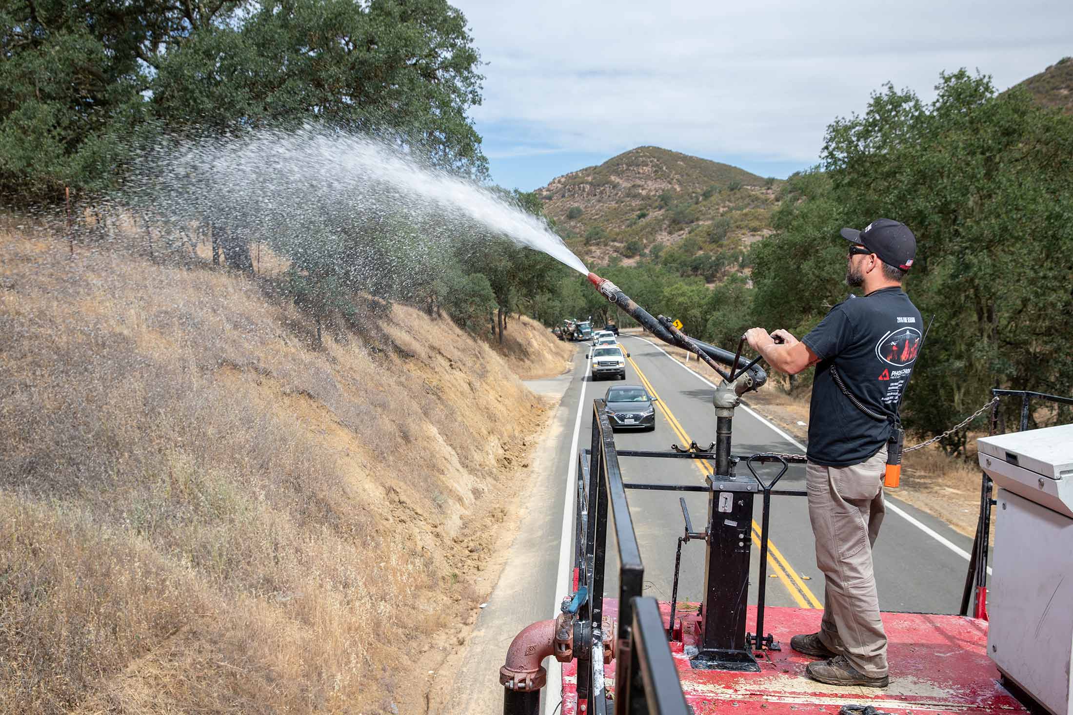 Eric Clancy, an operations manager at Perimeter Solutions, sprays the company’s Fortify fire retardant along the roadside in Paso Robles, Calif.