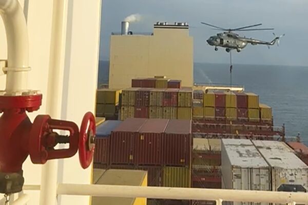 A helicopter hovers over the MSC Aries container ship near the Strait of Hormuz on April 13.