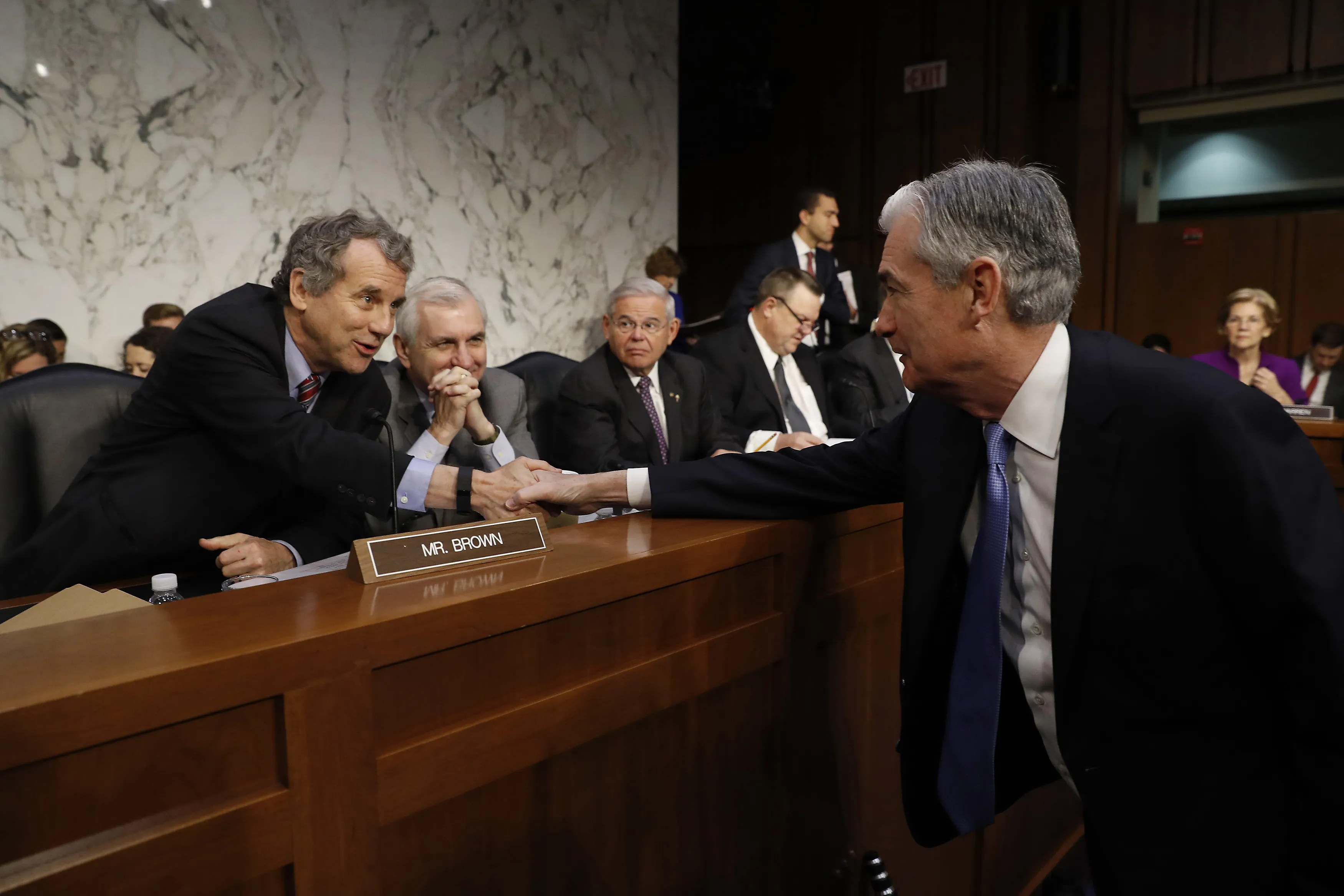 Sherrod Brow hakes hands with Jerome Powell.