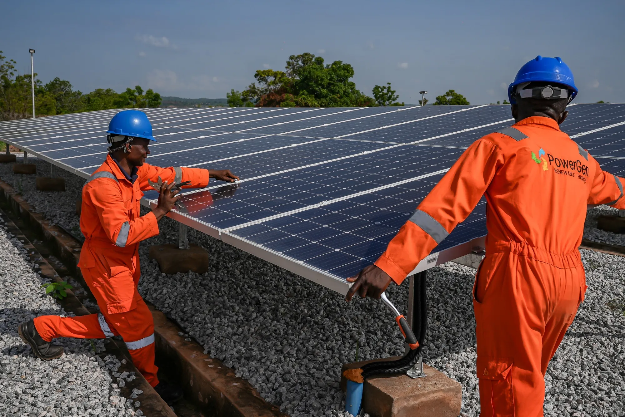 PowerGen employees work on solar panels on the Interconnected Mini Grid in Nasarawa, Nigeria.