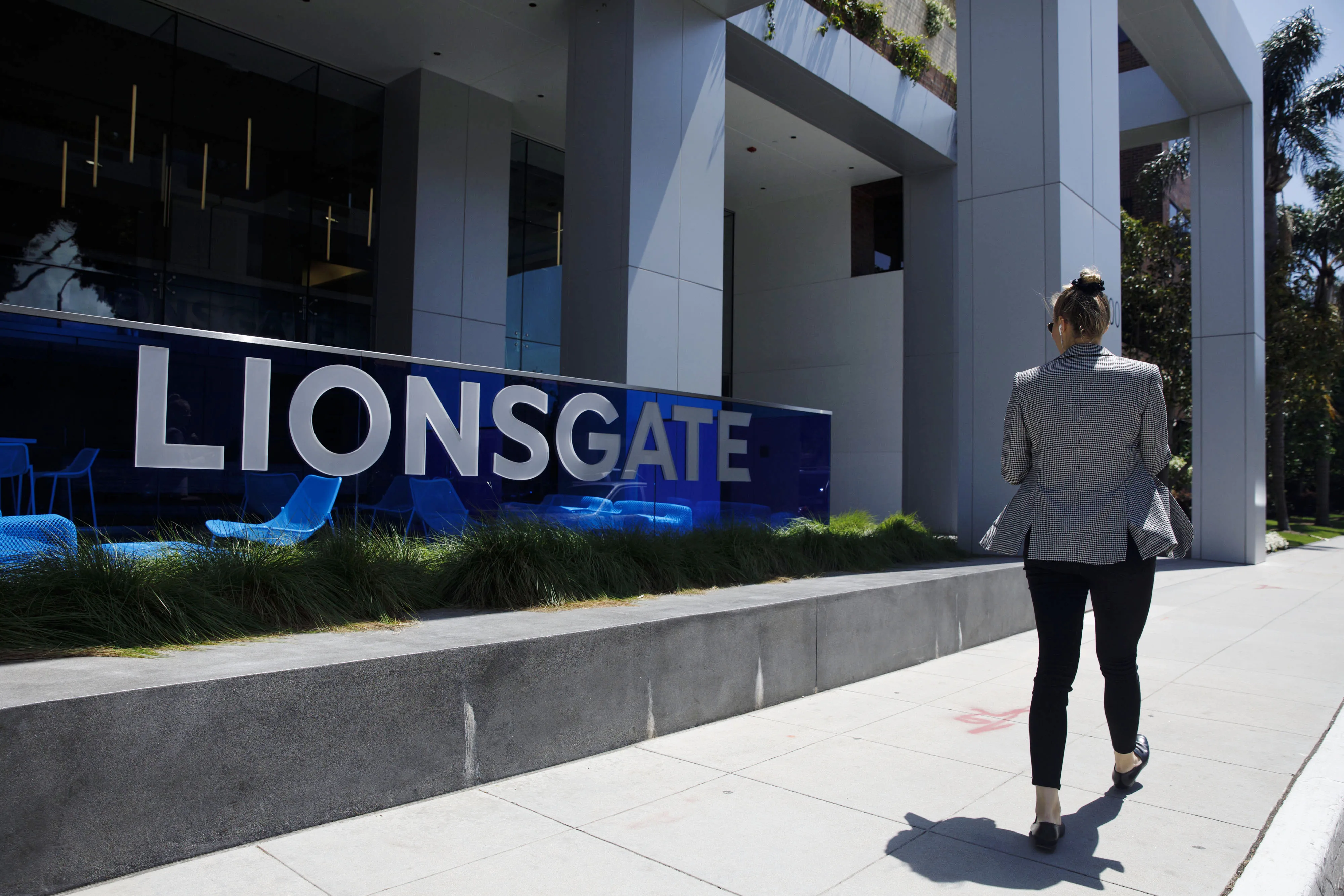 A pedestrian walks past Lions Gate Entertainment headquarters in Santa Monica, California.