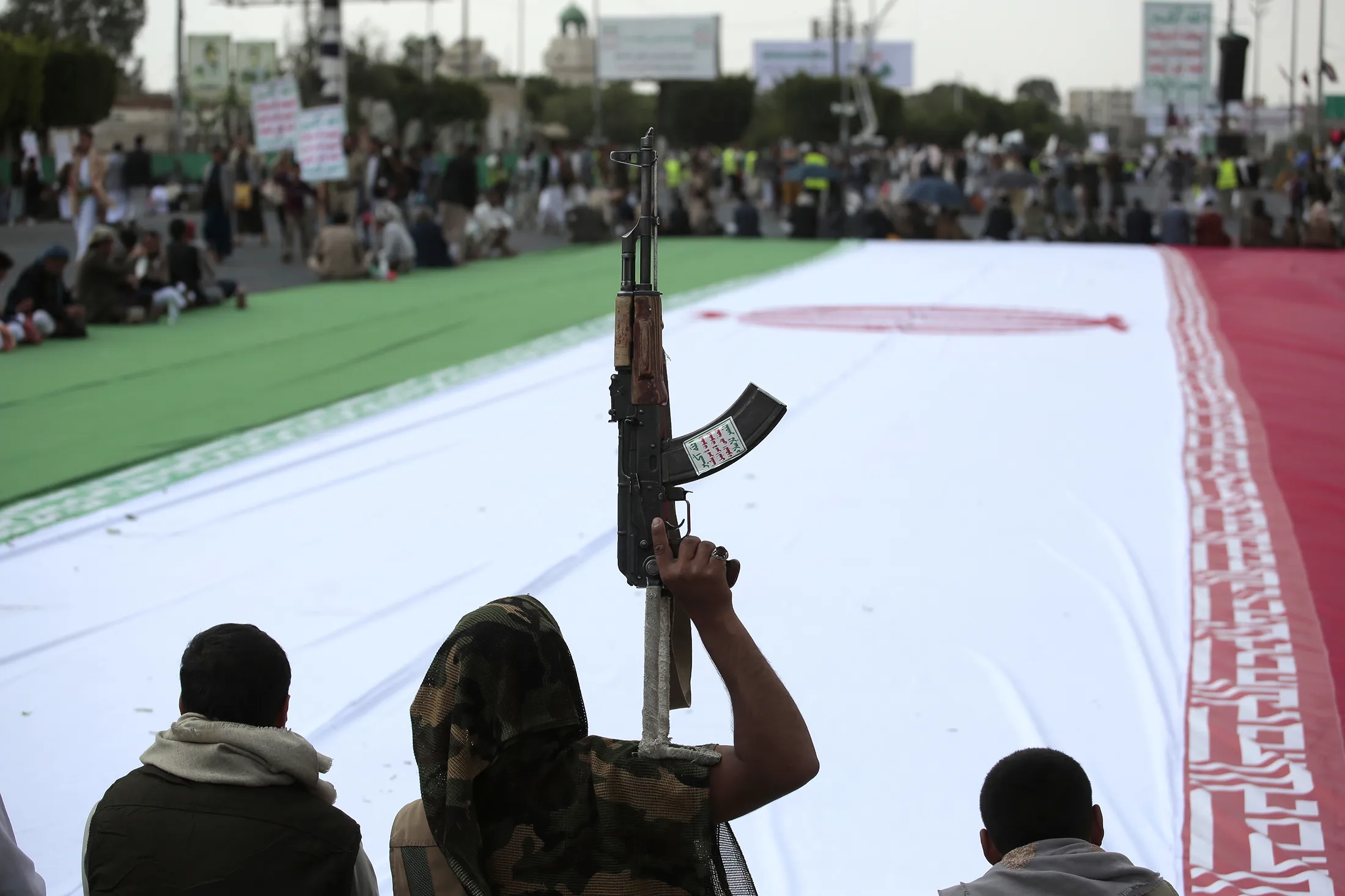 Houthi supporters surround an Iranian flag during an anti-US&nbsp;and anti-Israel rally in Sanaa, Yemen, on&nbsp;June 20.