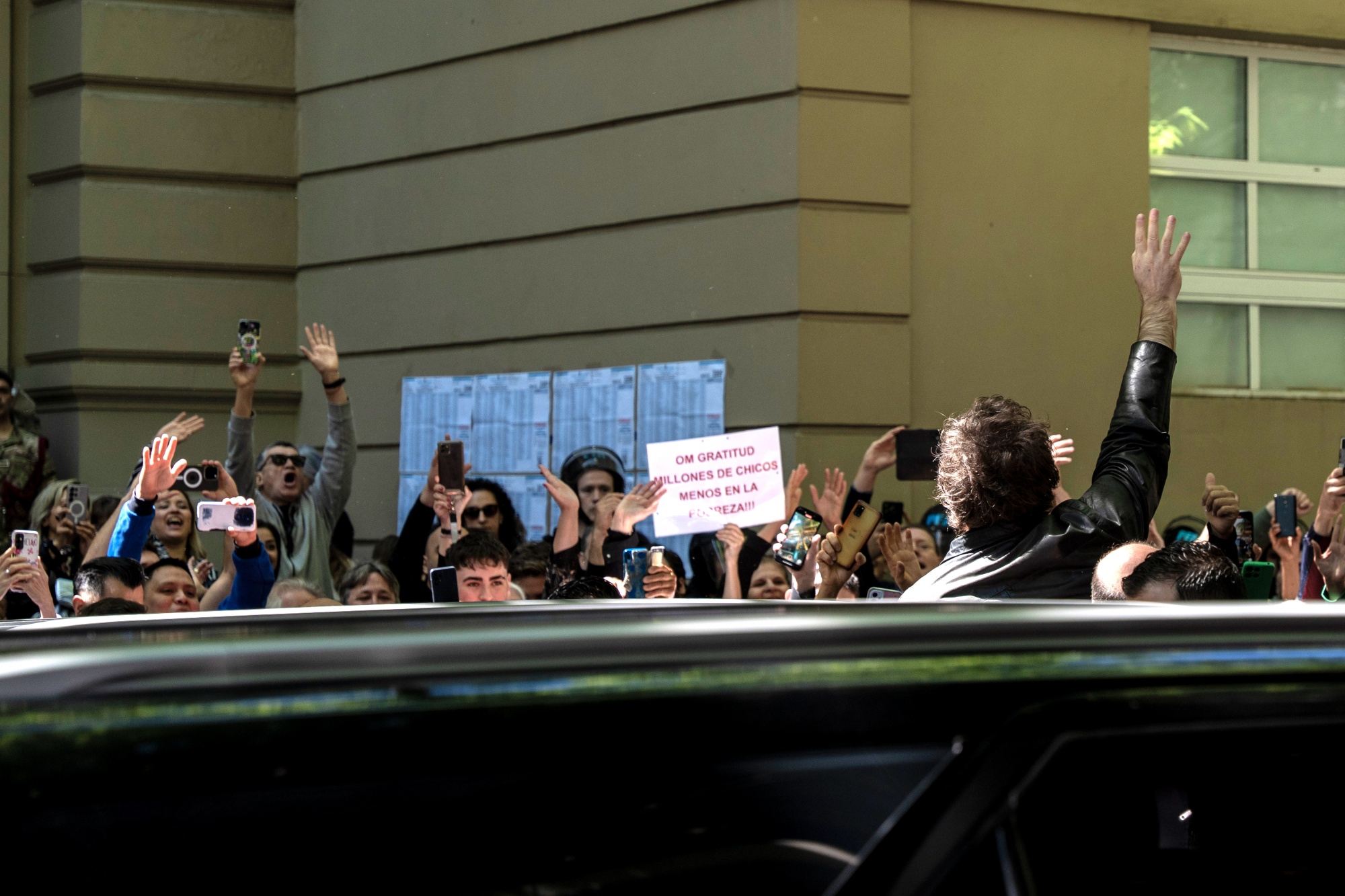 Javier Milei waves to supporters after casting a ballot at a polling station in Buenos Aires on Oct. 26.