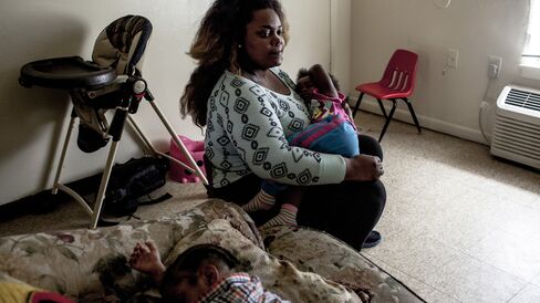 Jessica Johnson-Peterson holds her sleeping daughter.