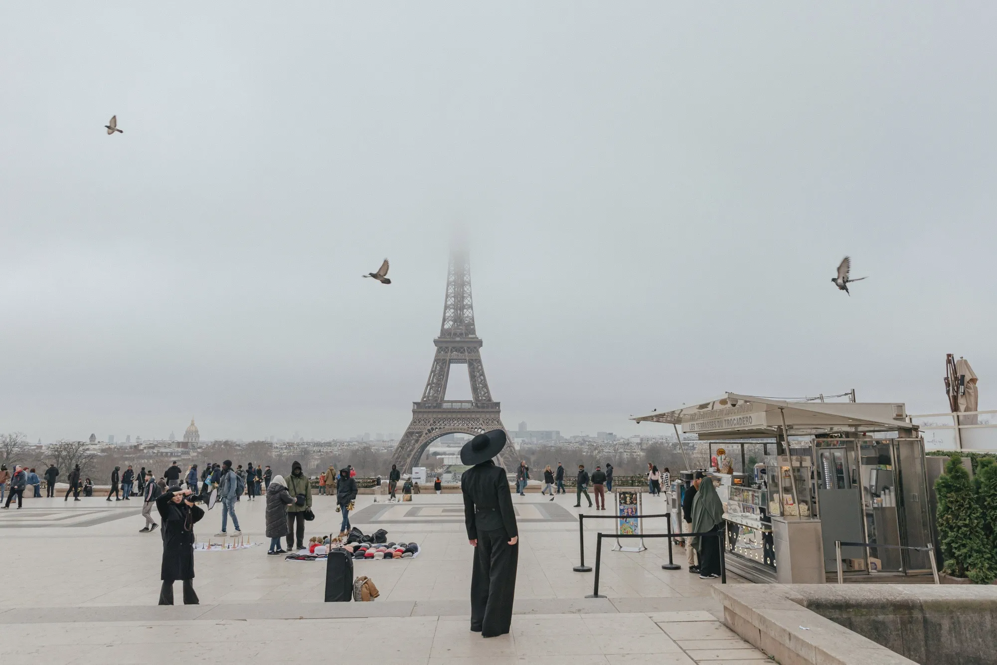Visitors at the viewpoint to the Eiffel tower in Trocadero Square in central Paris.