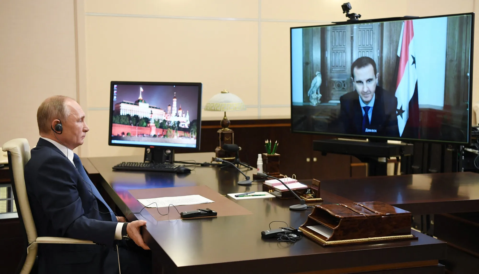 In this pool photograph distributed by the Russian state agency Sputnik, Vladimir Putin holds a video conference call with Bashar al-Assad in Moscow, in Nov. 2020.