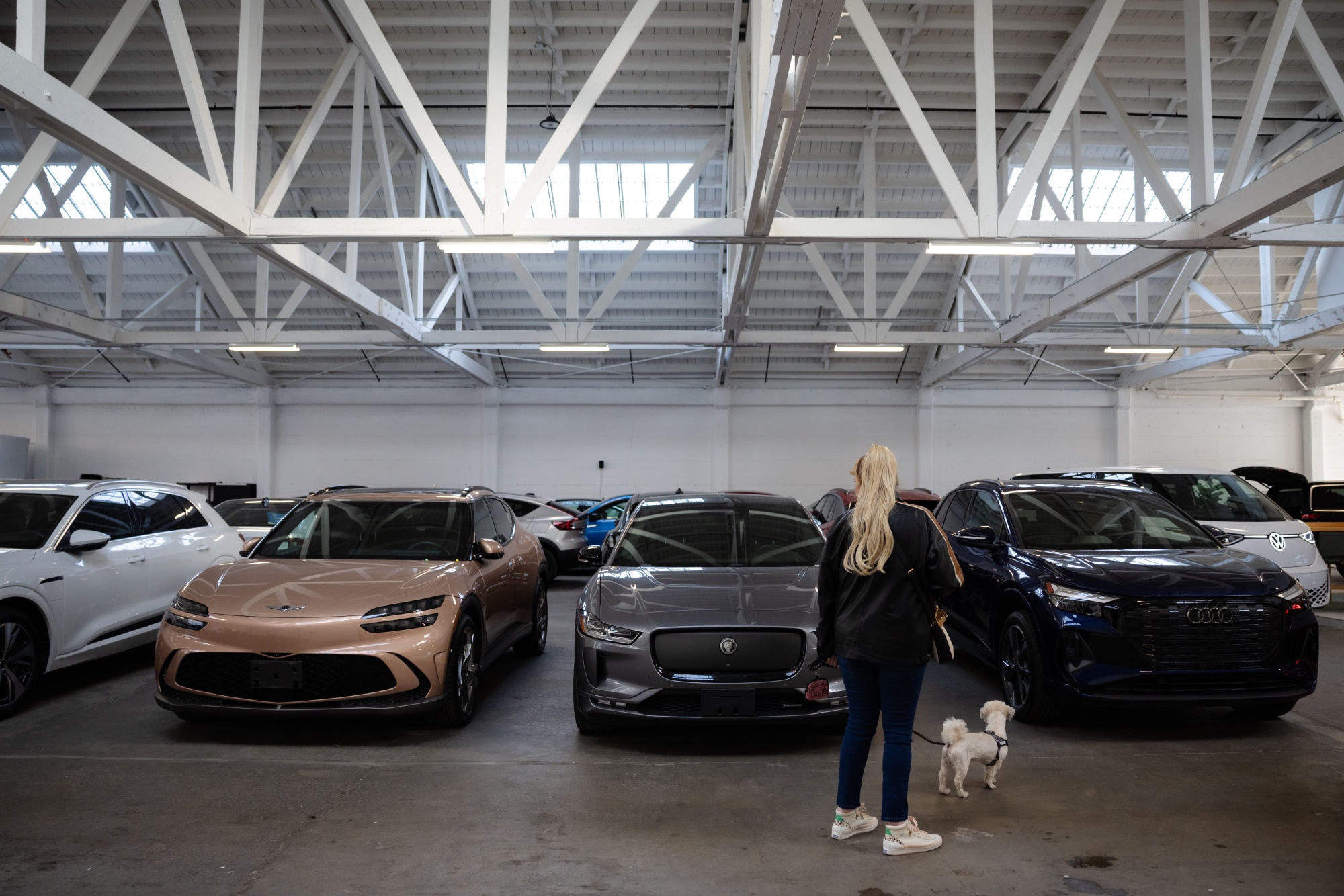 A customer looks at used electric cars inside the showroom of dealer Ever in San Francisco, on March 25.
