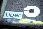 The Uber logo is displayed on a car in San Francisco, California. 