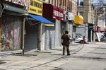 A worker for an independent contractor to&nbsp; UPS&nbsp;makes deliveries on a street with closed stores in the Borough Park neighborhood in the Brooklyn borough of New York, U.S., on April 7.