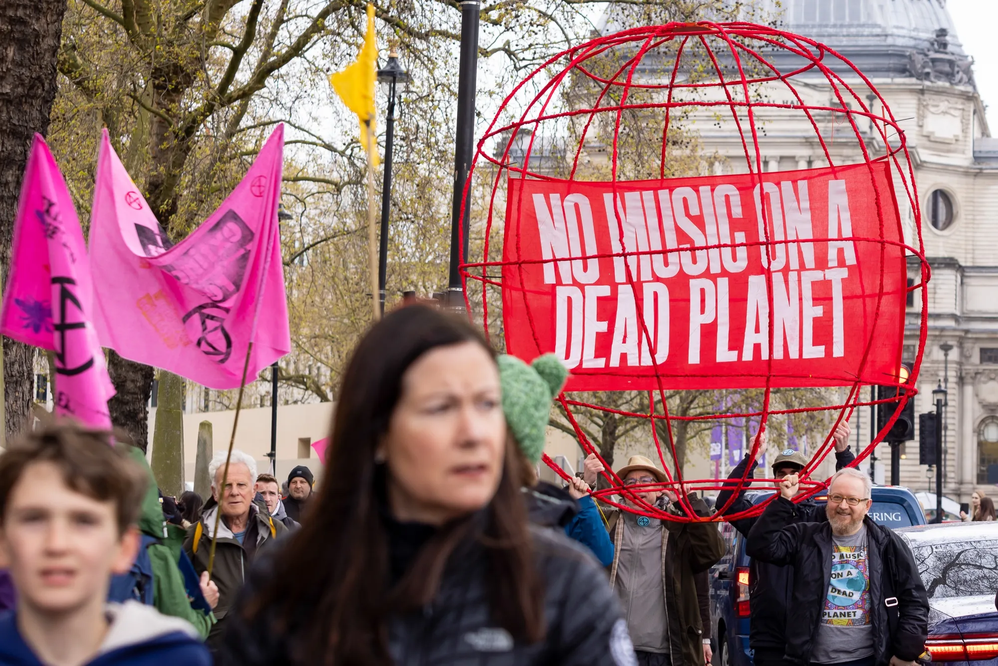 Protesters carry a sculpture with a banner inside reading "No Music On A Dead Planet" during the first day of the "The Big One" protest organized by Extinction&nbsp;Rebellion in London, UK, on Friday, April 21, 2023.&nbsp;