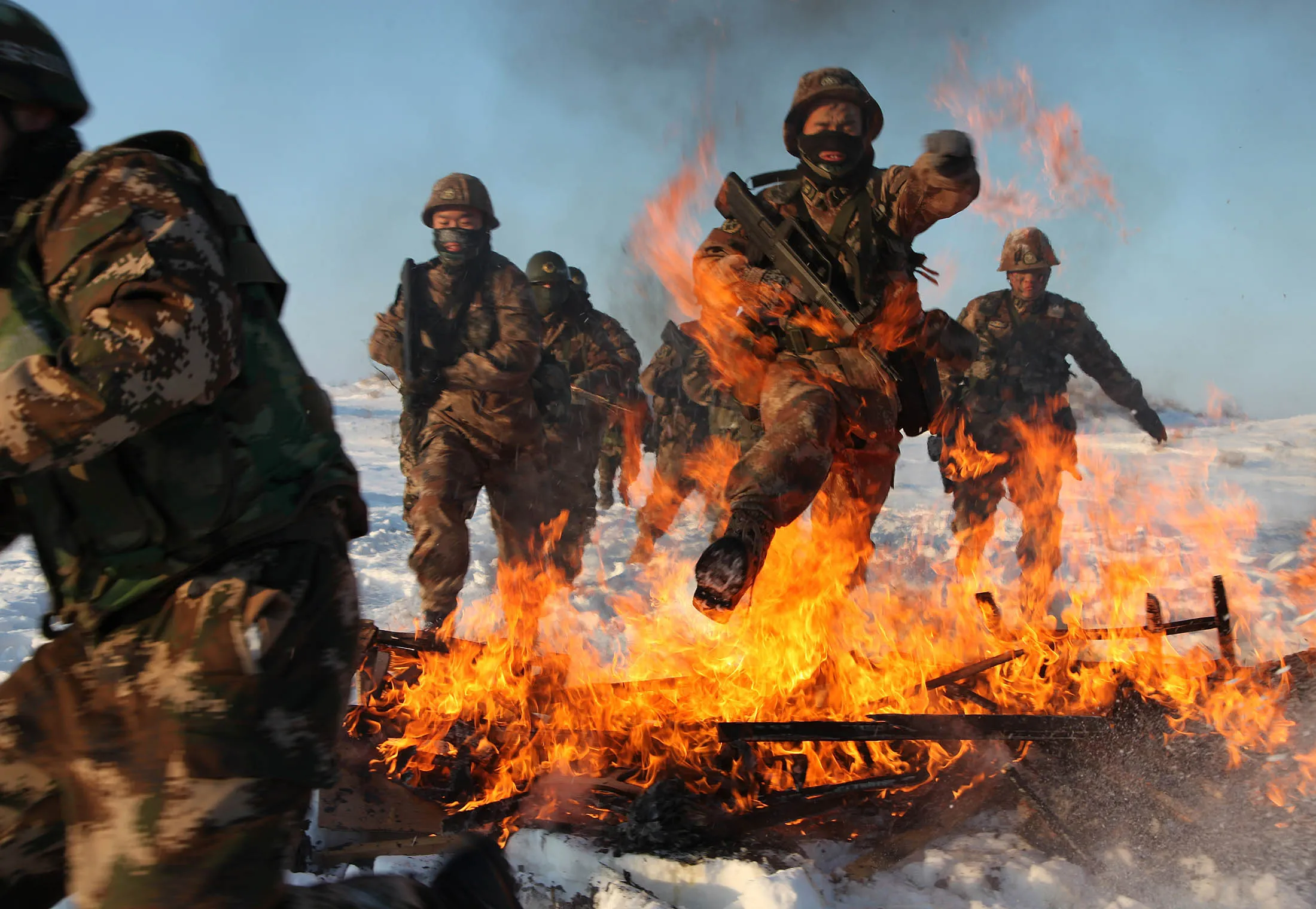 Chinese soldiers undergo training in Xinjiang Uyghur Autonomous Region. Defense spending in the Asia Pacific region is likely to increase due to China's military growth and territorial tensions.

