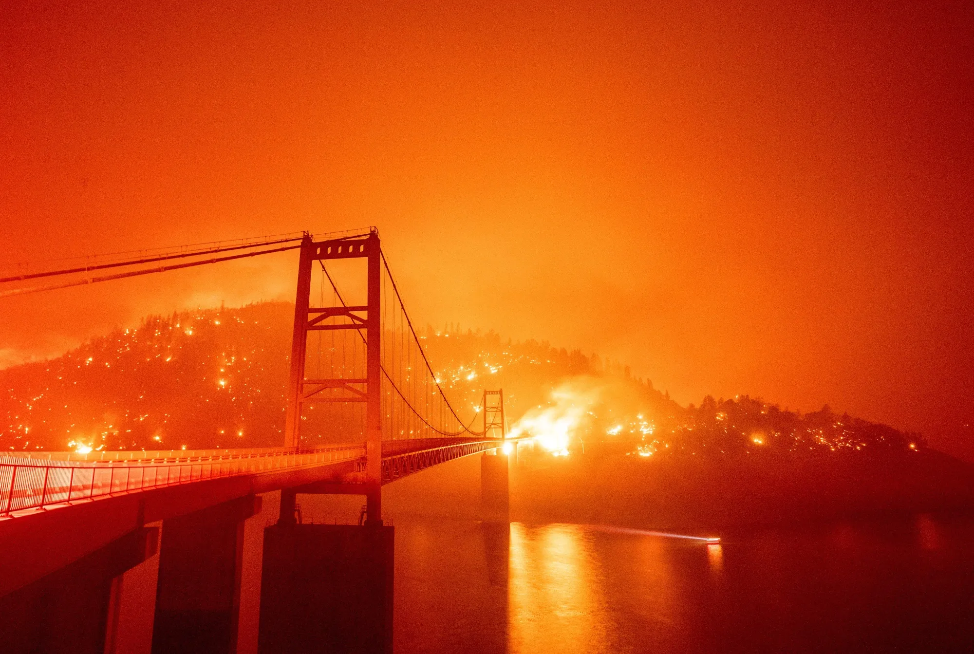 Fire surrounds California’s Bidwell Bar Bridge in Lake Oroville during the Bear fire.