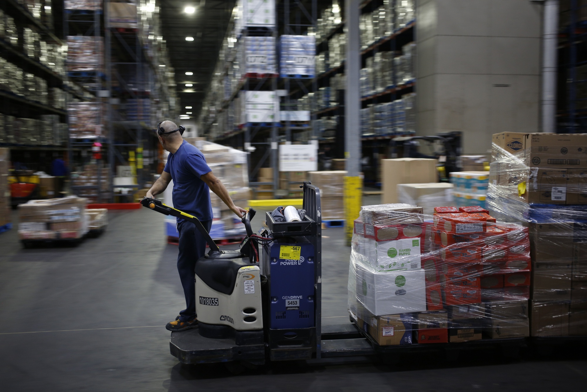 A worker drives a forklift through a Kroger Co. grocery distribution center in Louisville, Kentucky, on March 20.&nbsp;