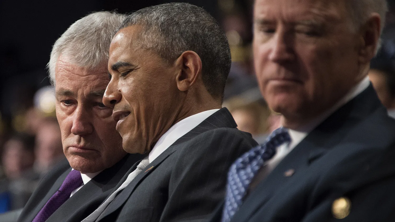 US President Barack Obama (C) speaks with departing US Secretary of Defense Chuck Hagel (R) during at an Armed Forces Farewell Ceremony for Hagel at Joint Base Fort Myer-Henderson in Arlington, Virginia, on January 28, 2015.
