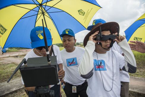 Officials check aerial imagery from a drone during a test flight at the Palembang military airbase complex. Photographer: Rony Zakaria/Bloomberg
