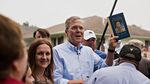Republican presidential candidate Jeb Bush comments on his likeness on a book cover handed to him for an autograph while greeting attendees during a campaign stop in Washington, Iowa, on June 17, 2015.
