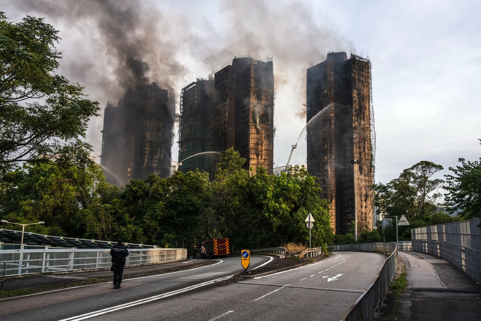 Smoke rises from residential buildings as fires continue to burn at Wang Fuk Court on Nov. 27.