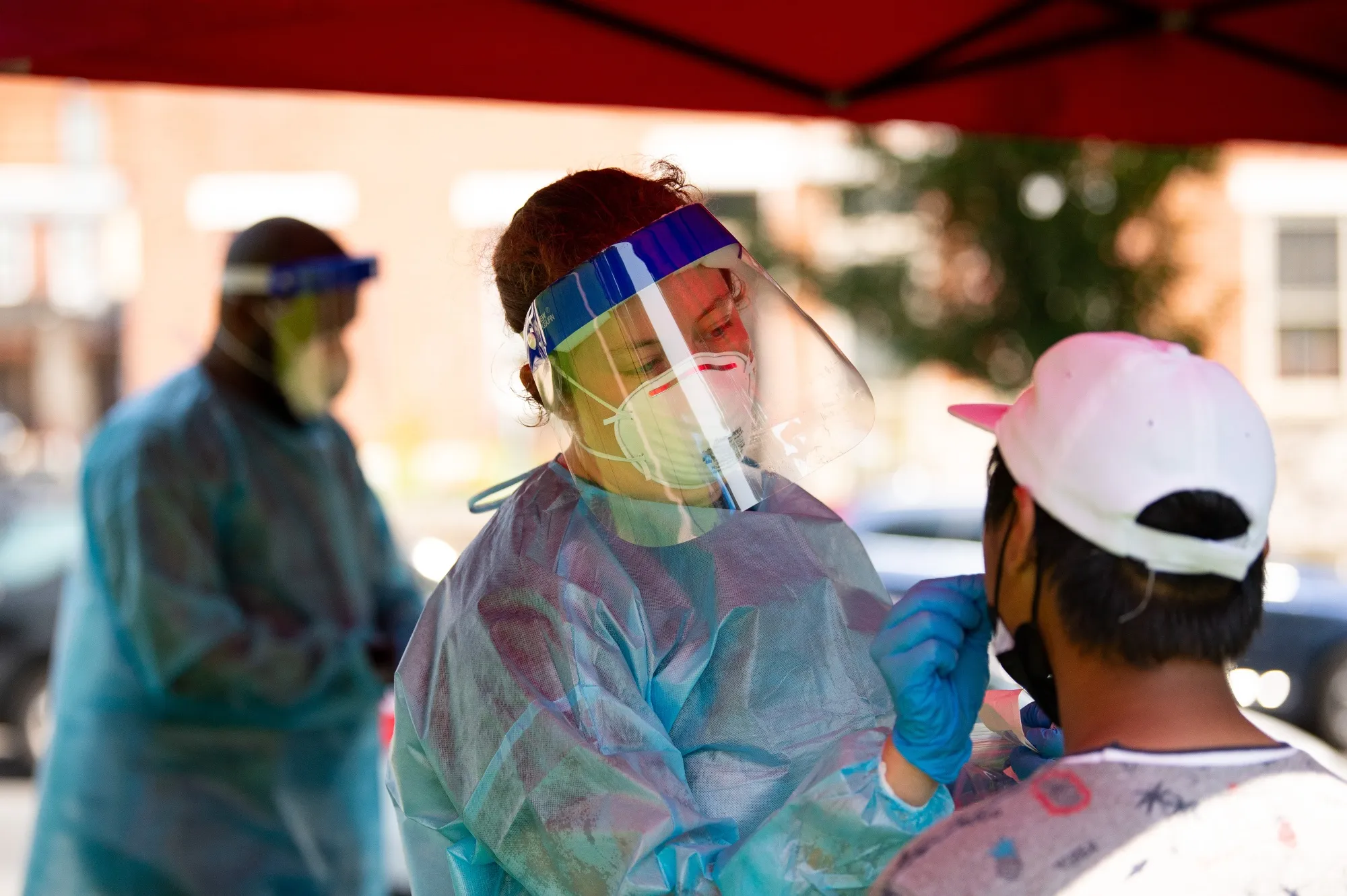 A healthcare worker administers a Covid-19 test at a testing site in Philadelphia, Pennsylvania, on Aug. 12.