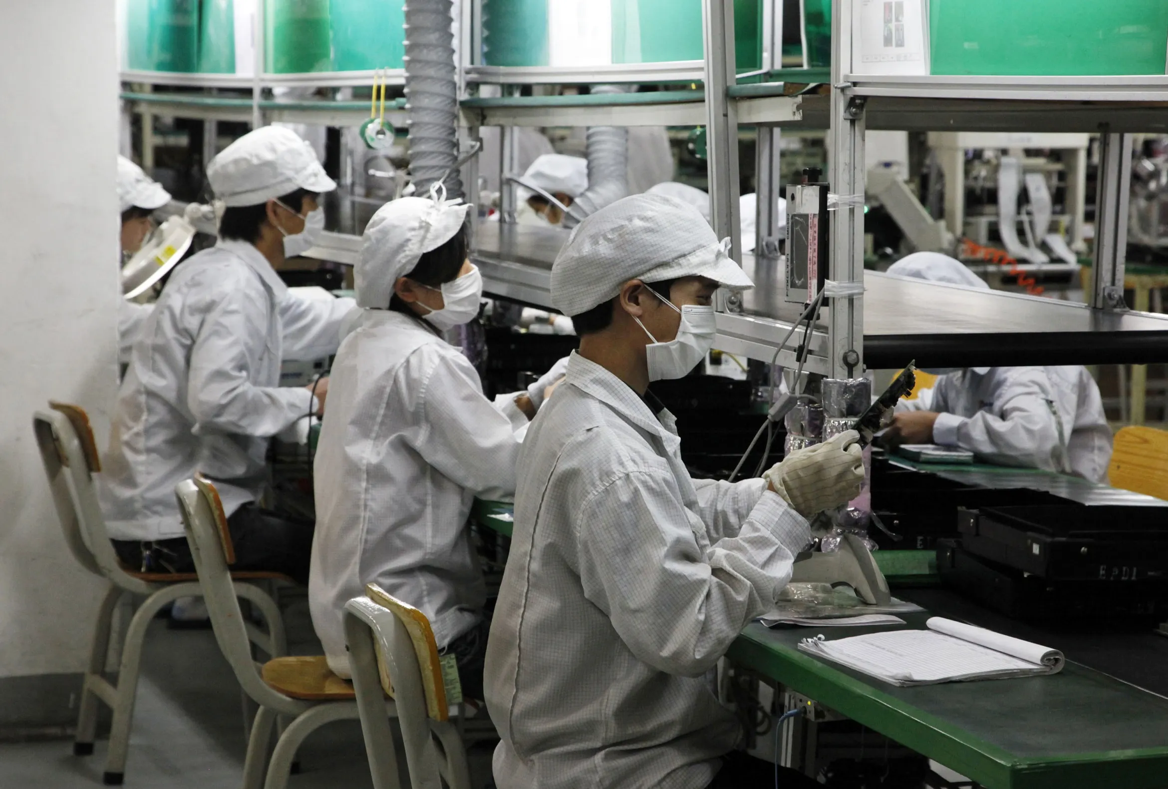 Employees work on the assembly line at Hon Hai Group's Foxconn plant.&nbsp;
