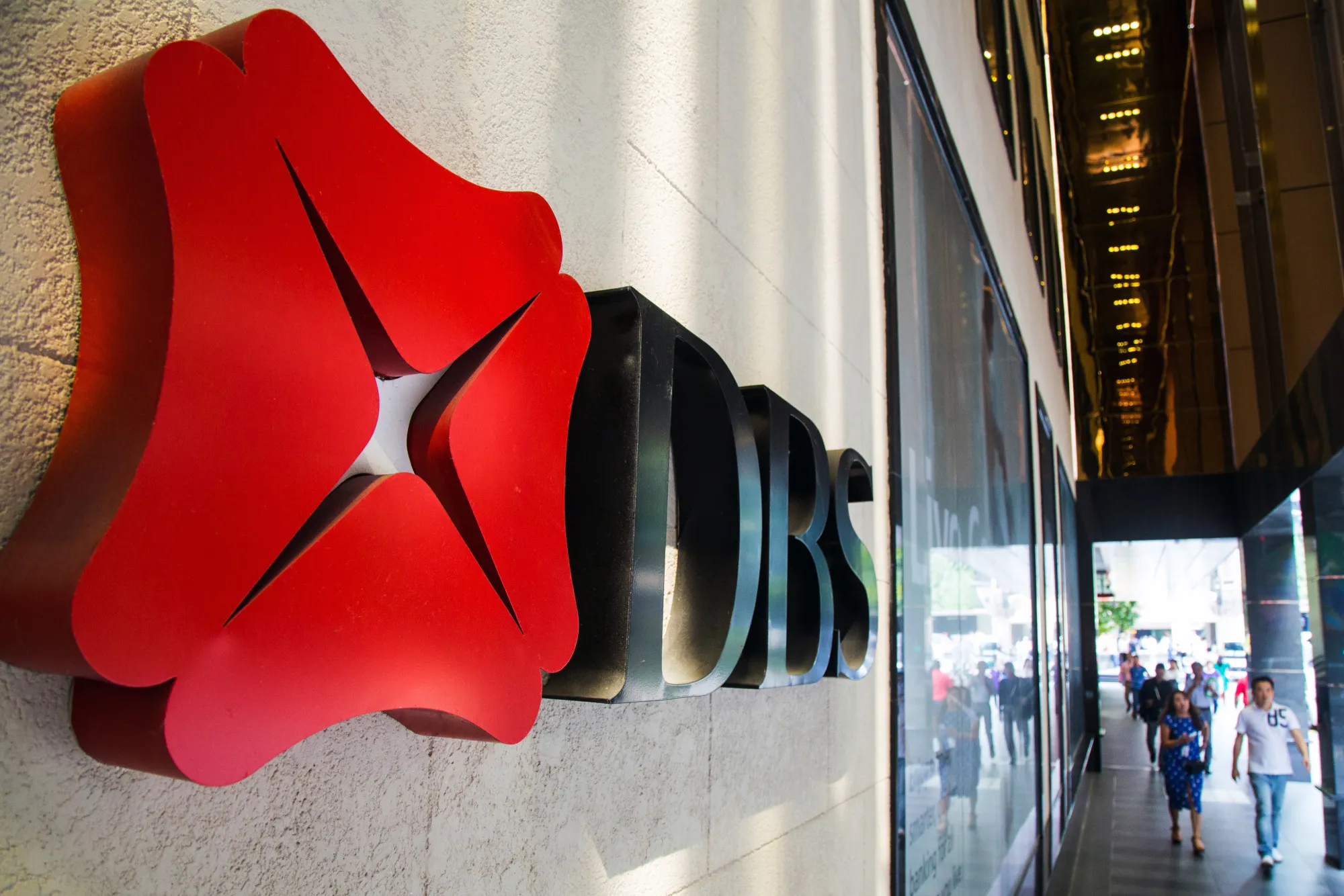 Signage is displayed at a DBS Group Holdings Ltd. branch in the central business district of Singapore, on Friday, Feb. 10, 2017. DBS is scheduled to release earnings results on Feb. 14.