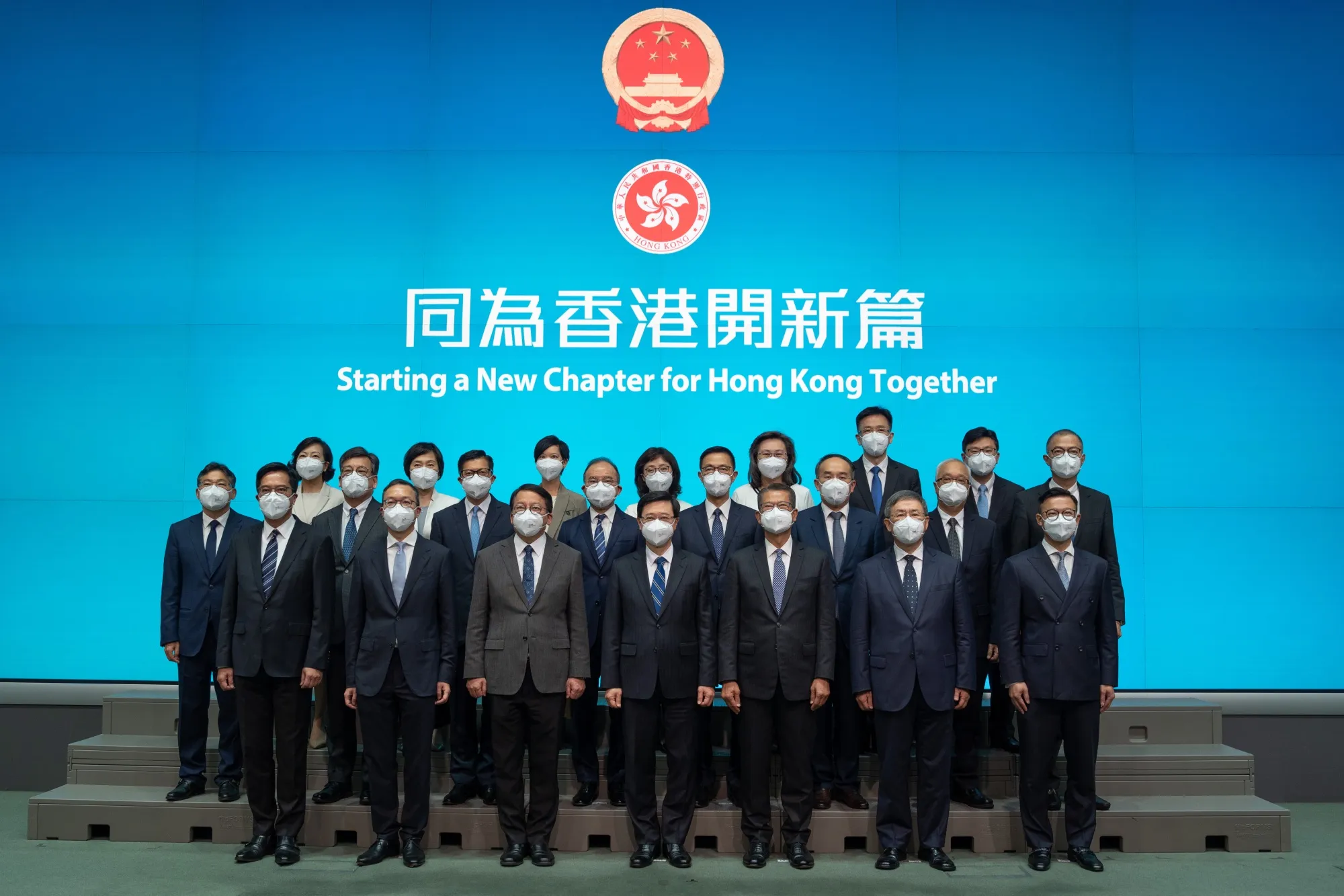 John Lee, bottom center, and the Principal Officials at a news conference, on June 19.