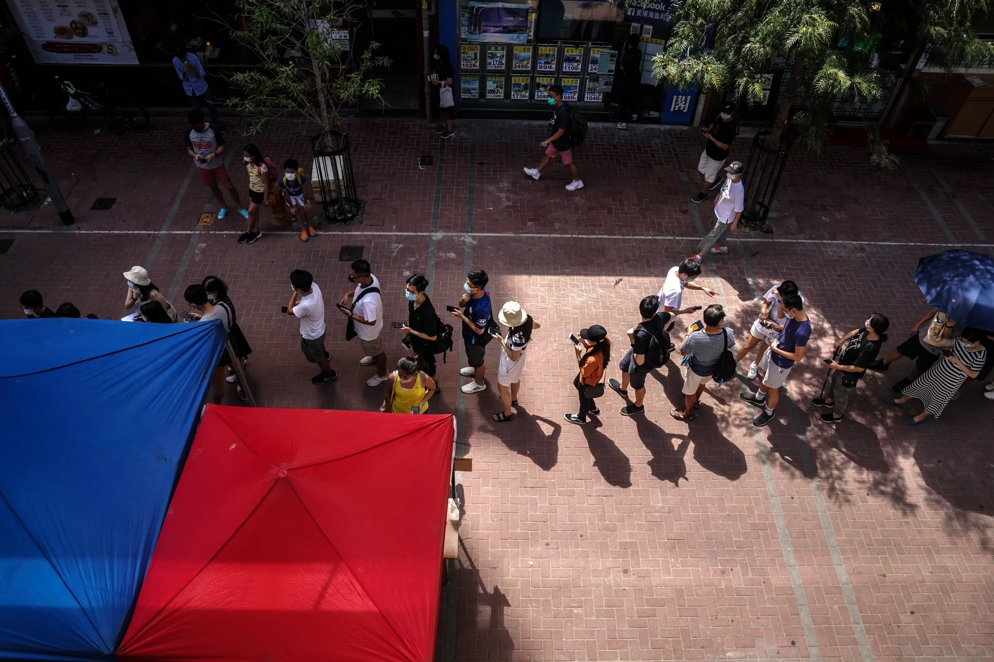People line up at a polling station to vote during an unofficial primary election in Hong Kong, July 11.