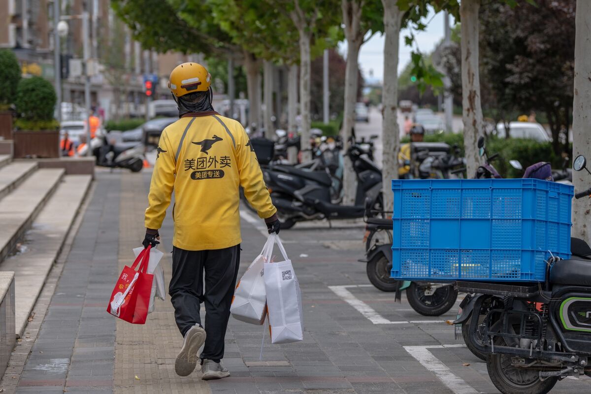 JD.com's costly bid to challenge Meituan in food delivery, while the latter enters the e-commerce space, has led to a loss of ~$70B in combined market value (Charlotte Yang/Bloomberg)