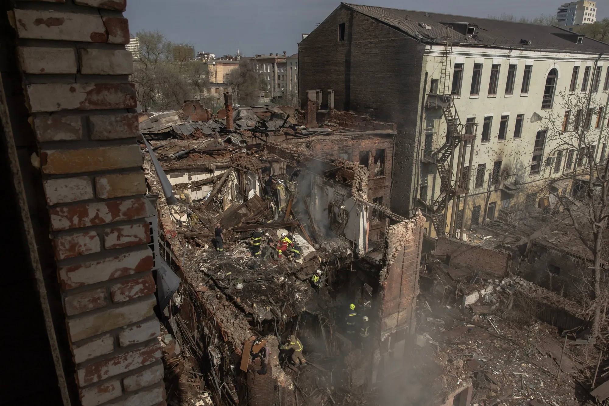 Ukrainian rescuers work at the site of damaged buildings following a Russian air attack in Dnipro, on April 16.