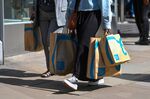 Shoppers carry bags from Primark&nbsp;in Manchester, UK.