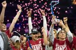 Stanford head coach Tara VanDerveer, right, holds up the winning trophy while her team cheers after they won an NCAA college basketball game for the Pac-12 tournament championship against the Utah Sunday, March 6, 2022, in Las Vegas. (AP Photo/Ellen Schmidt)