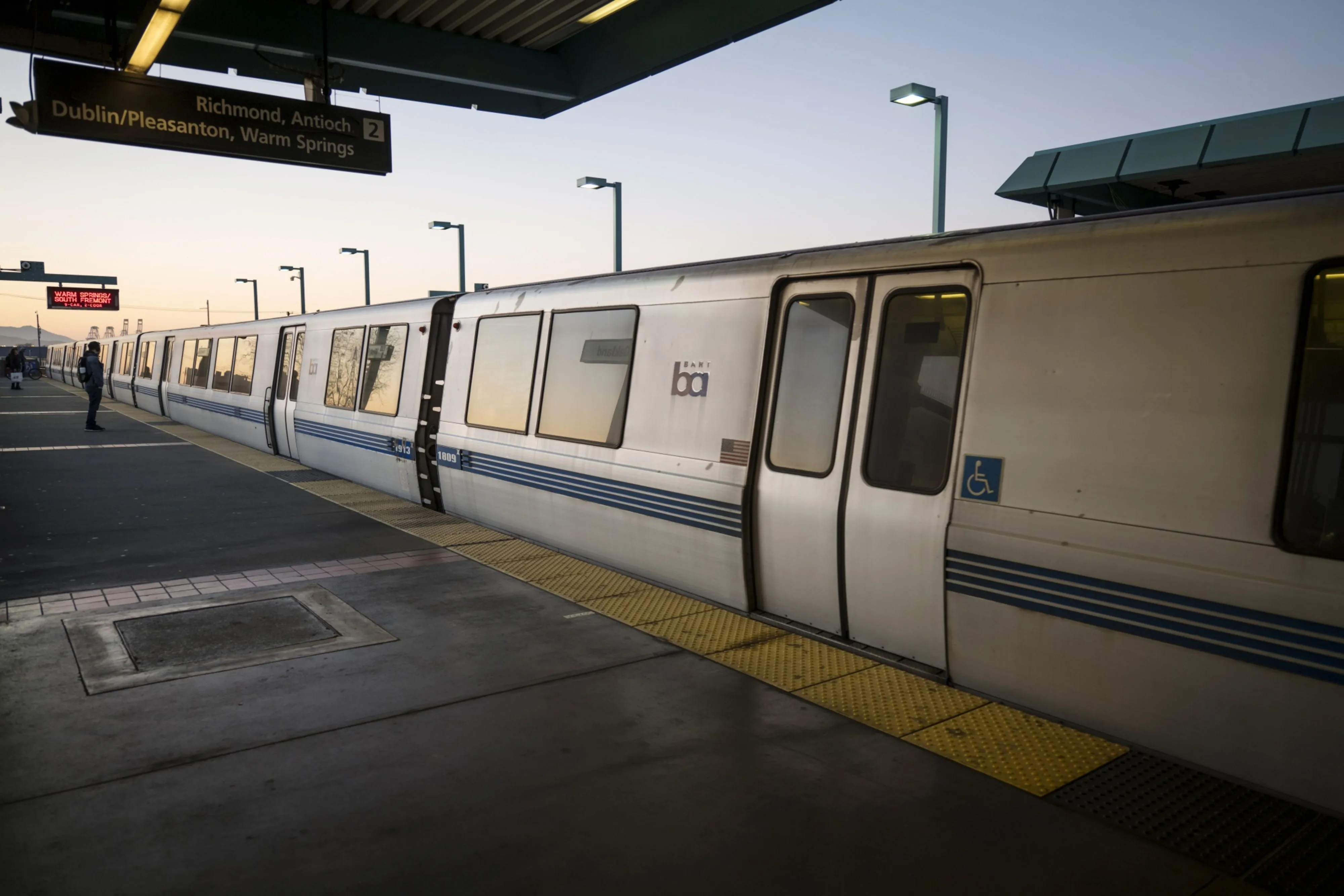 A person stands on a Bay Area Rapid Transit (BART) train platform in Oakland.&nbsp;