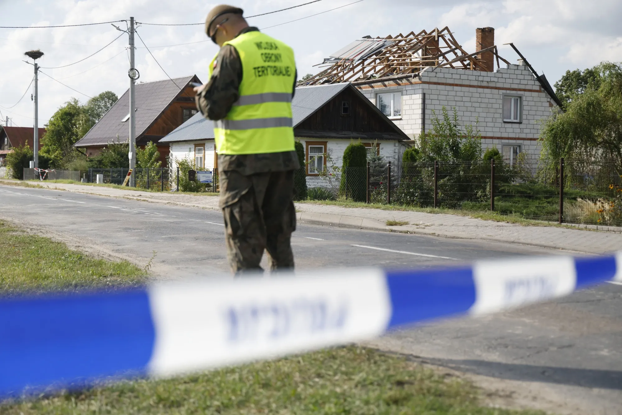 Officials inspect damage to a property after it was struck by drone debris, in Wyryki-Wola, Poland, on Sept. 10.