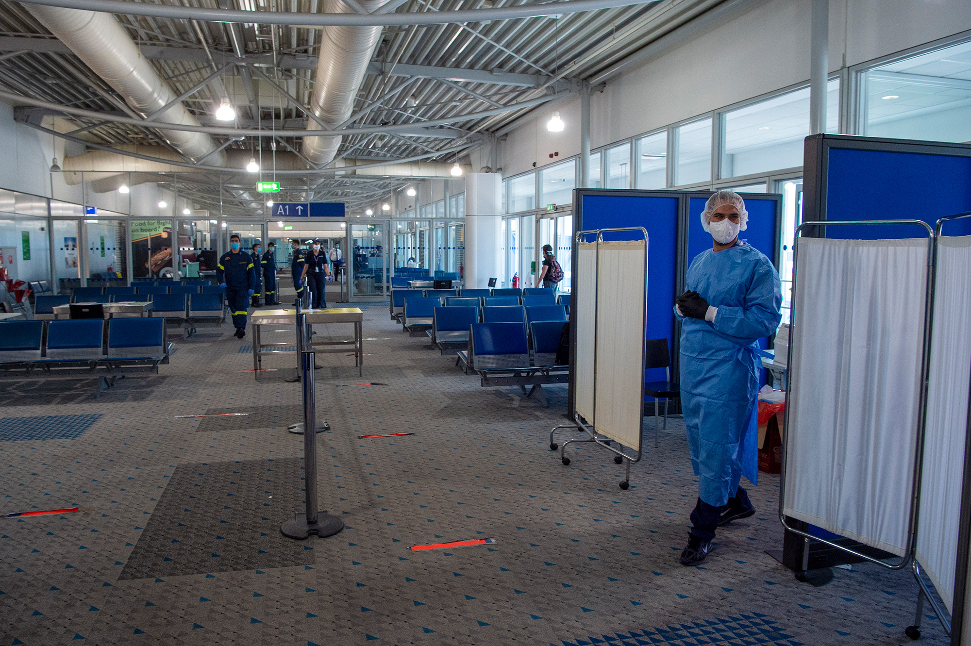 A medical worker mans a&nbsp;testing station for passengers arriving at Eleftherios Venizelos International Airport in Athens.