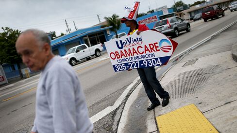 A sign directing people to an Insurance company where they can sign up for the Affordable Care Act, also known as Obamacare, before the February 15th deadline in Miami.