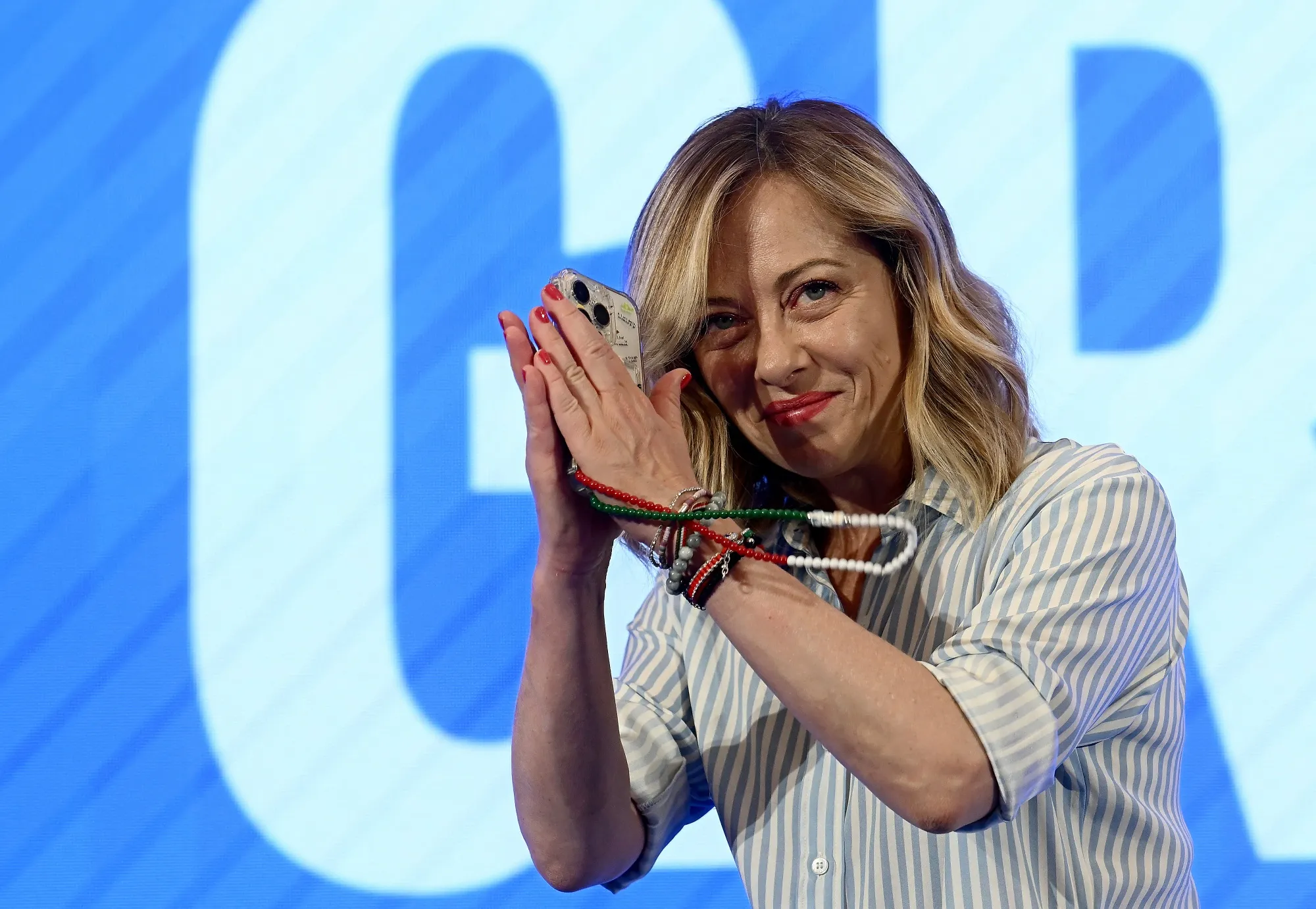 Giorgia Meloni getures during a press conference following the results of the European elections.