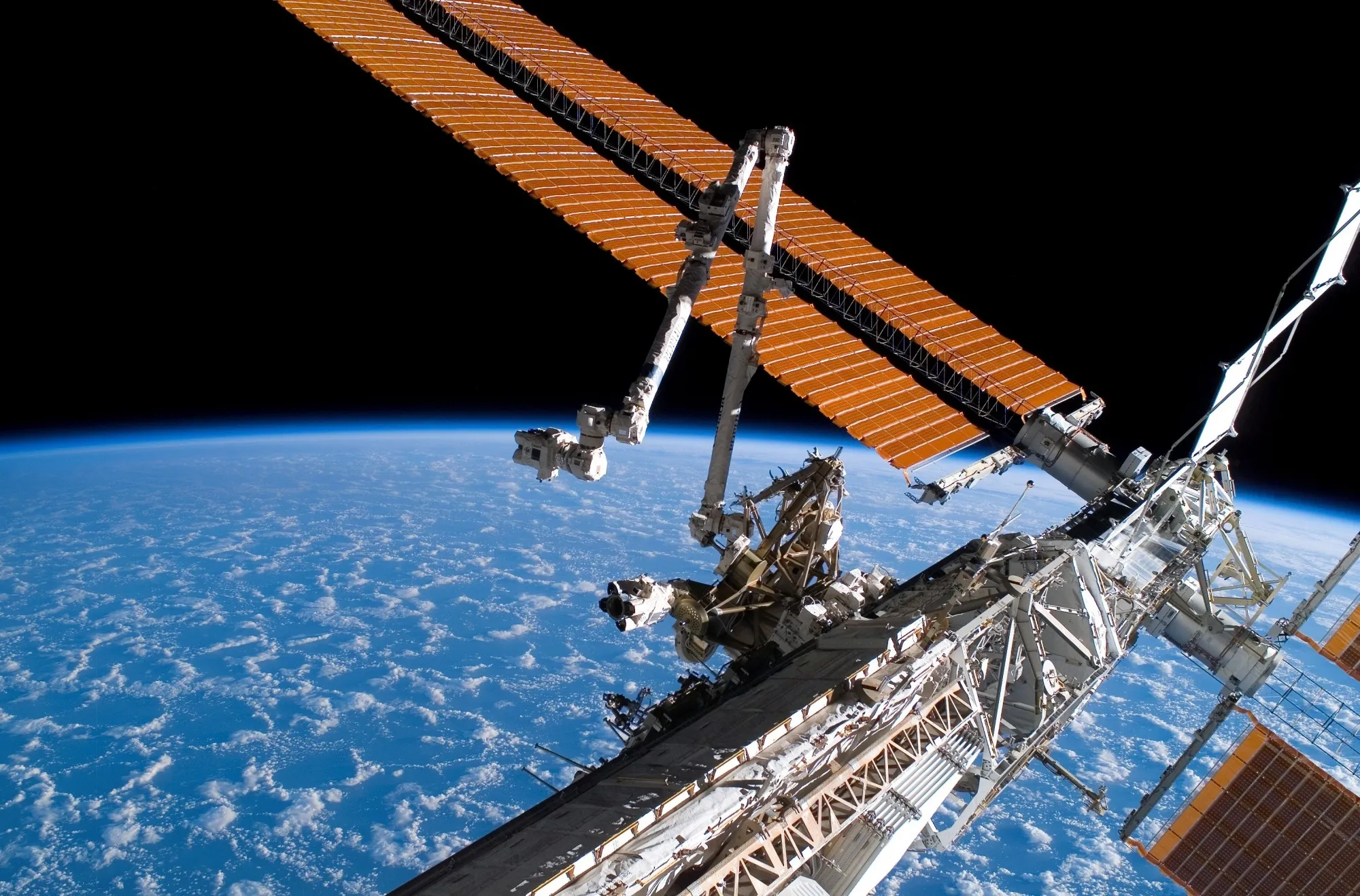 The Canadarm and solar array panel wings on the International Space Station.
