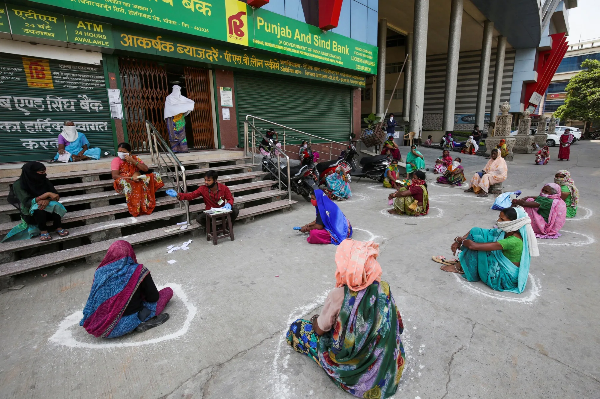 Women maintain social distancing outside a bank as they wait to collect their pension during a government-imposed nationwide lockdown&nbsp;in Bhopal on April 15.&nbsp;
