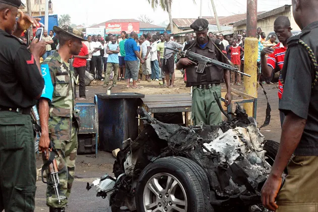 Police at the site of an explosion outside a church in northern Nigeria on Easter Sunday. At least 20 people were killed