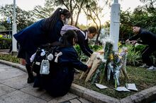 Students leave flowers outside Wang Fuk Court on Nov. 28.