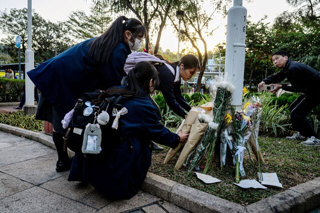Students leave flowers outside Wang Fuk Court on Nov. 28. 