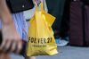 A customer carries a Forever 21 Inc. shopping bag near a store in the Union Square neighborhood of New York, U.S., on Thursday, Aug. 29, 2019. Forever 21 Inc. is preparing for a potential bankruptcy filing as the fashion retailers cash dwindles and turnaround options fade, according to people with knowledge of the plans.